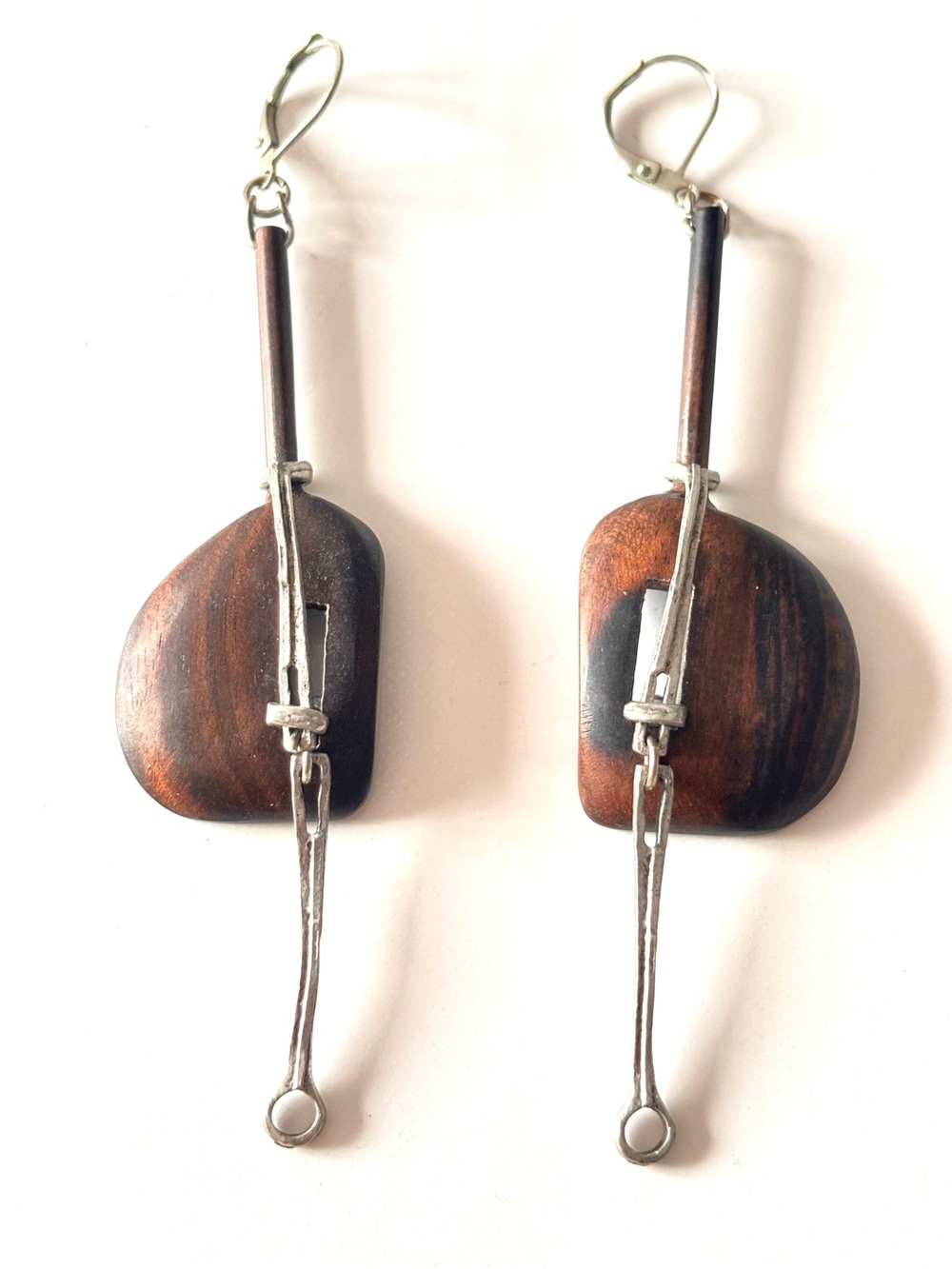 Handmade dangle earrings combine dark wood with tin geometric elements